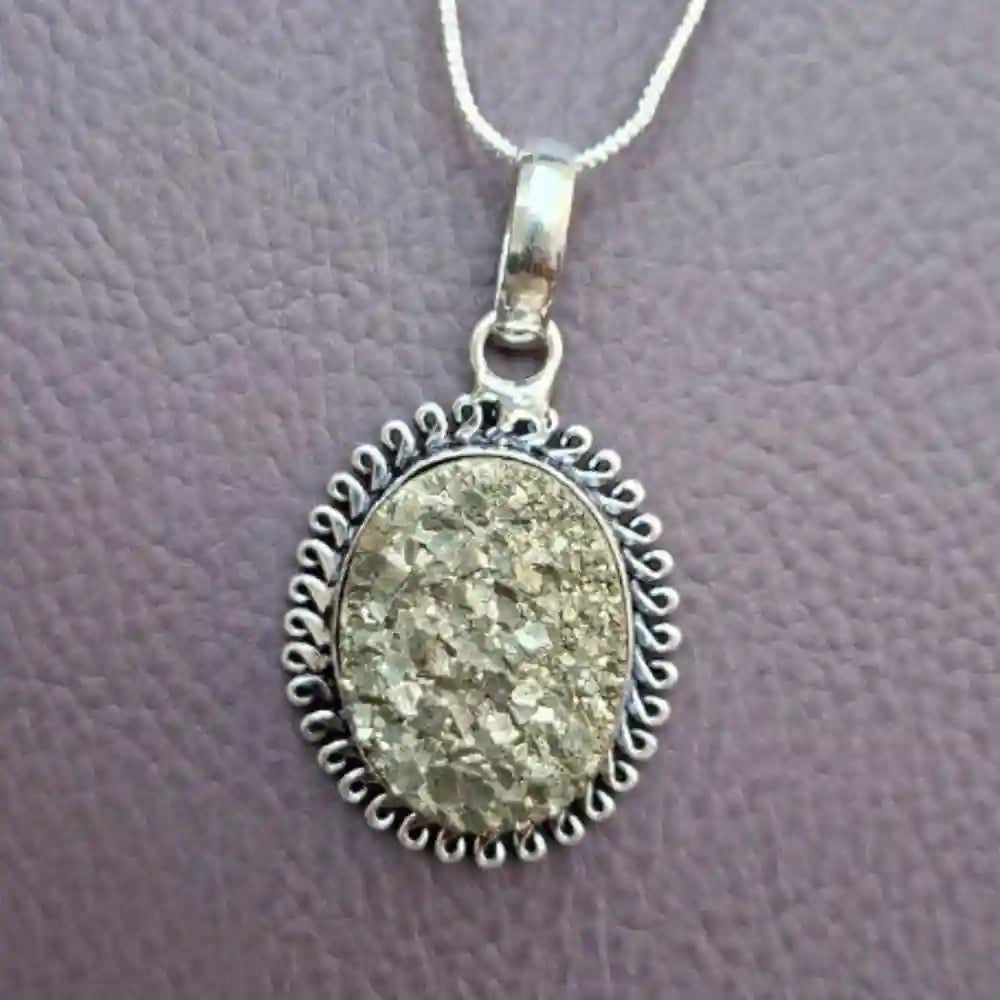 Golden pyrite pendant with intricate silver setting, perfect for jewelry enthusiasts