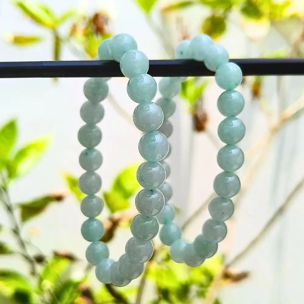 CRYSTCOP Green Aventurine Bracelet made of smooth round light green beads hanging on a black rod