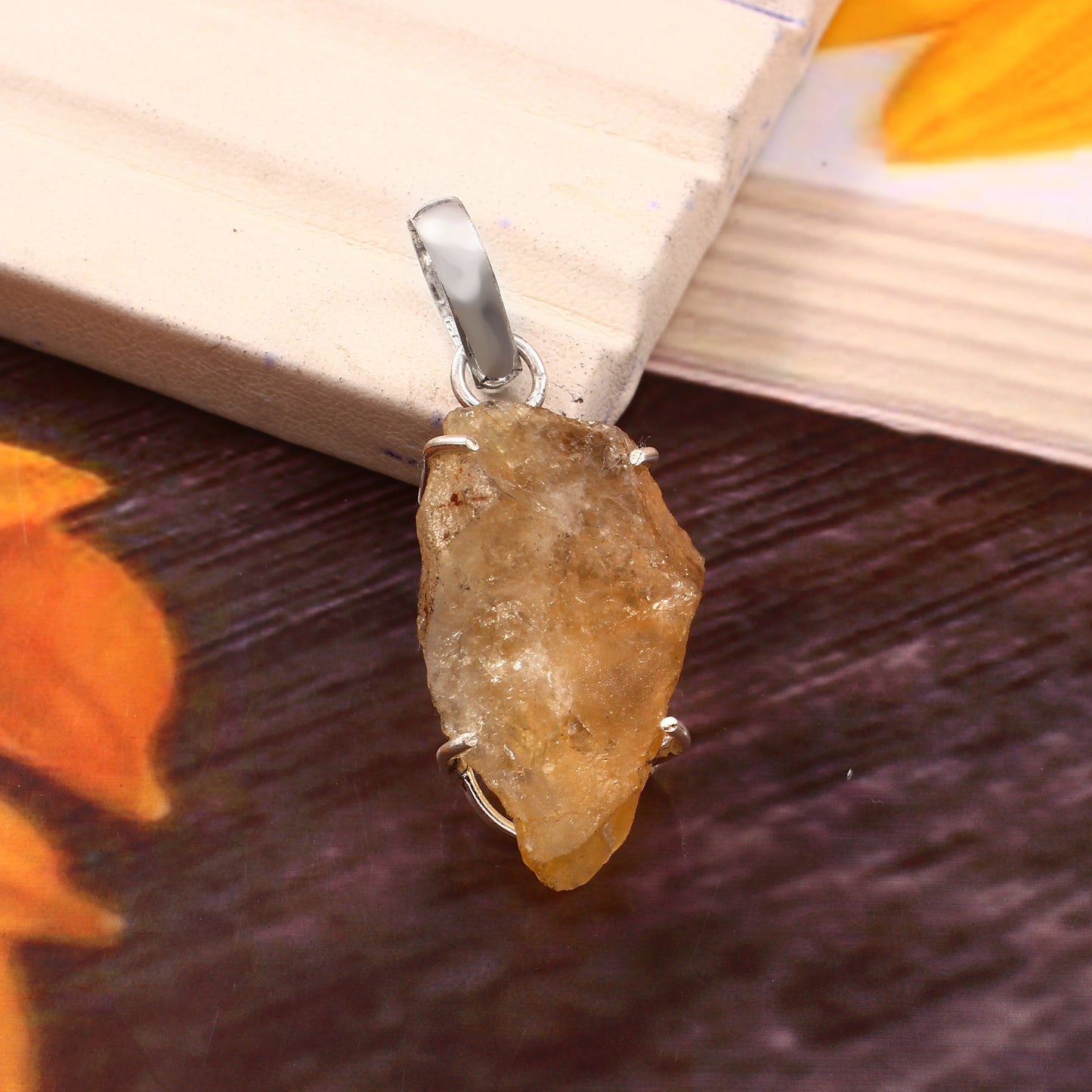 CRYSTCOP natural citrine pendant with rough gemstone and silver setting on wooden background