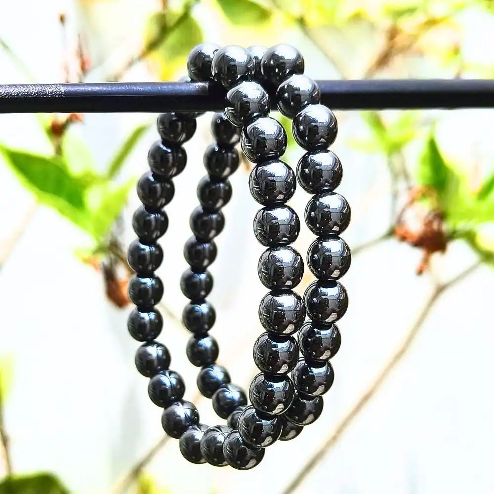 CRYSTCOP hematite bracelet 8mm with polished round beads displayed outdoors