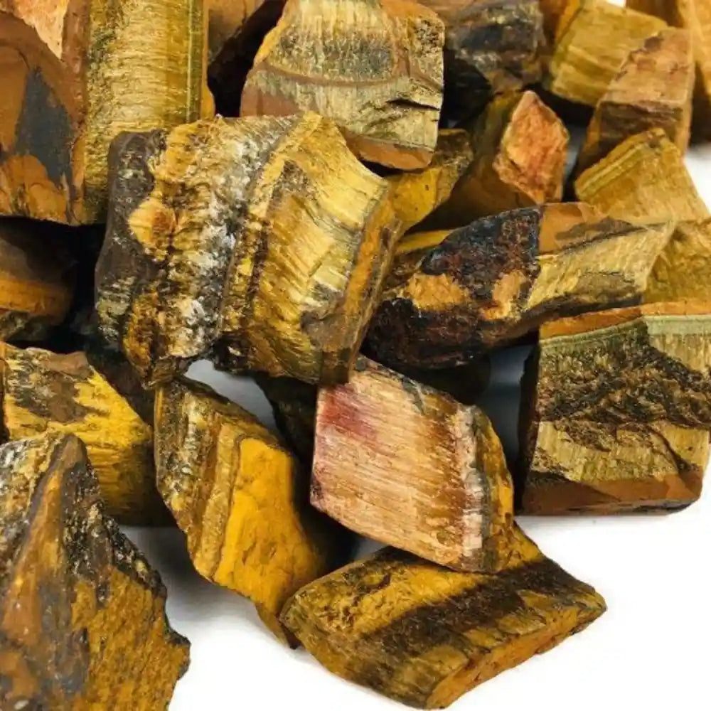 Collection of raw natural Tiger's Eye stones showcasing unique golden-brown patterns and textures