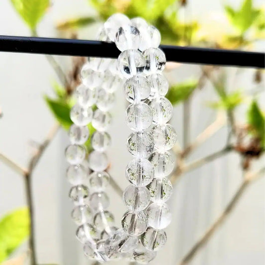 CRYSTCOP clear quartz bracelet made of polished round transparent beads hanging on black rod