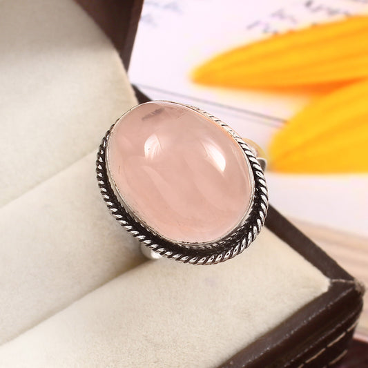 Elegant CRYSTCOP German silver rose quartz jewelry ring with an oval stone on a soft display