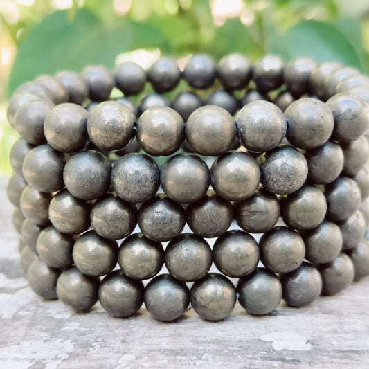 Stacked golden pyrite bracelet featuring smooth, round beads for a stylish accessory