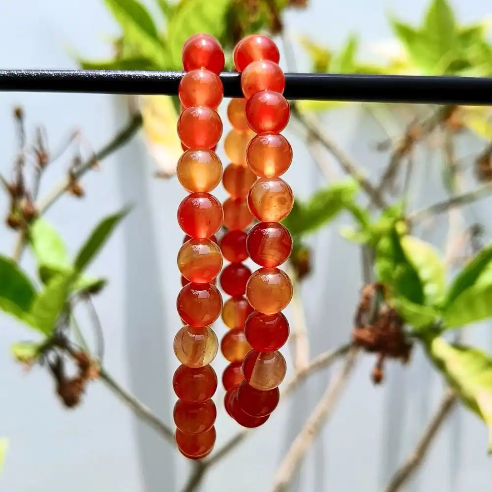 CRYSTCOP carnelian bracelet 8mm featuring smooth round red-orange beads strung in a simple design